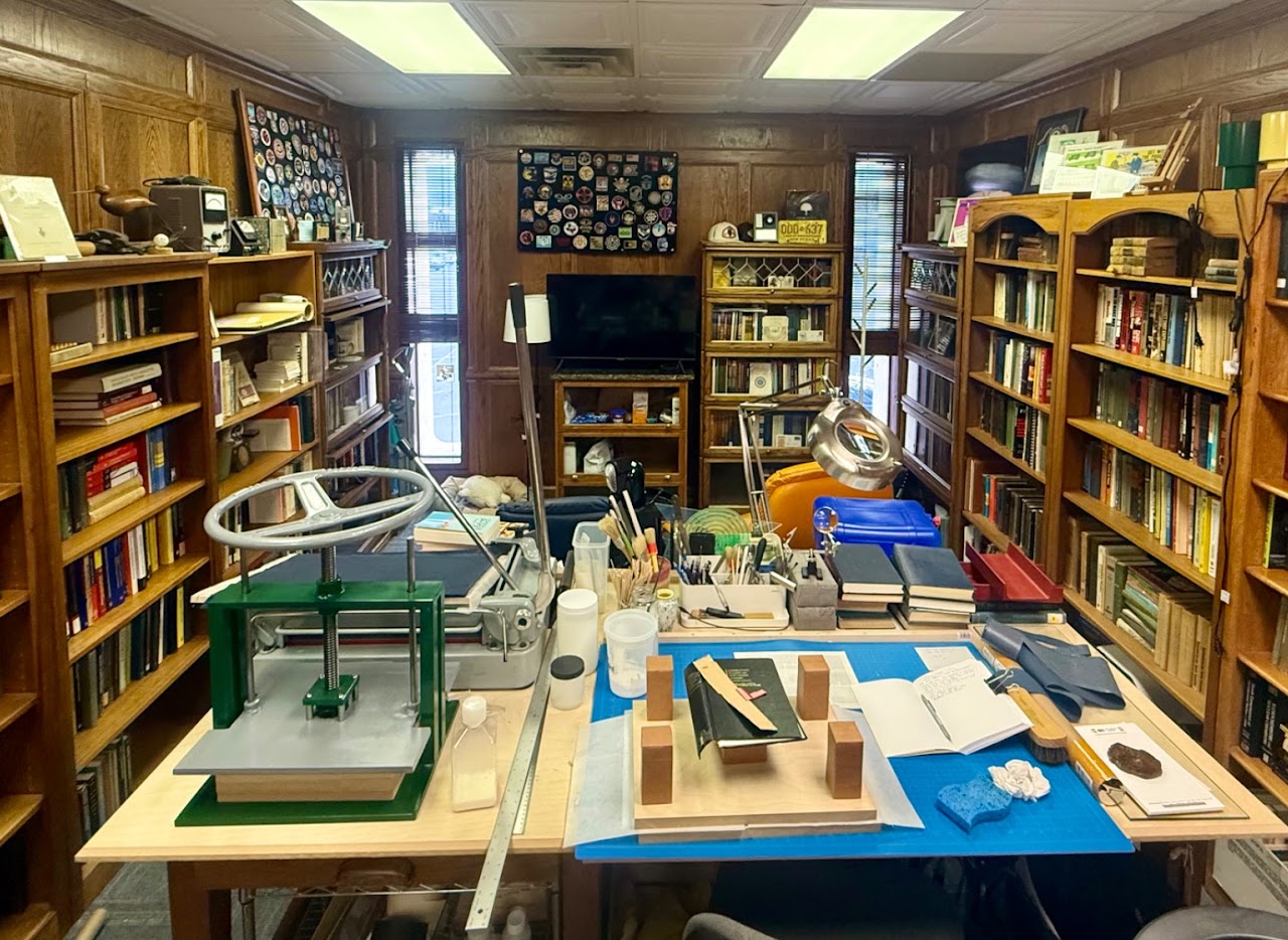 Bookshelves and a bookbinding workbench inside Nerdy J’s Los Alamos bookshop.